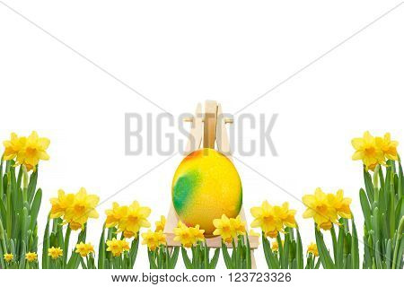 Frame daffodils with easter egg on an easel in front of a white background.