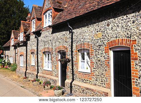HAMBLEDON, UK - JULY 10, 2015 - Pretty brick and flint cottages with dormer windows along a village street Hambledon Oxfordshire England UK Western Europe, July 10, 2015.