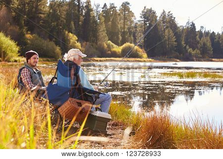 Father and adult son fishing lakeside, Big Bear, California