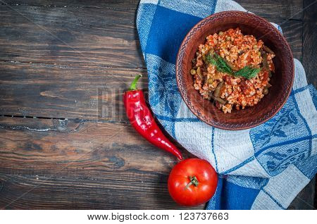 Appetizing healthy rice with vegetables in plate on a wooden background. Selective focus. Top view