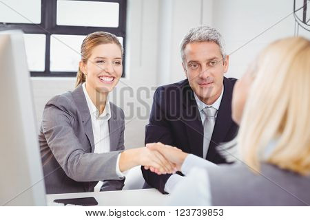 Smart business people handshaking with client in meeting room