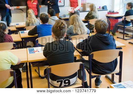 ENSCHEDE NETHERLANDS - MAR 22 2016: Kids of 11 years old sitting behind their desks in a school class.
