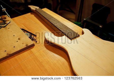Billet of wood for bass guitar. Manufacture and repair of musical instruments. Installing the guitar frets.