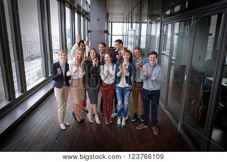 Group shot of business people in modern office hall. Post processed with vintage film filter.