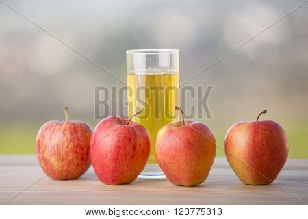 apples and apple juice on a wooden table, outdoor