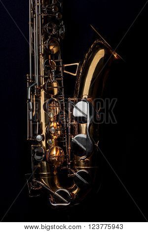 Tenor Saxophone isolated on a black background.