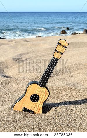 Photo Picture of a Guitar on the Sand Beach