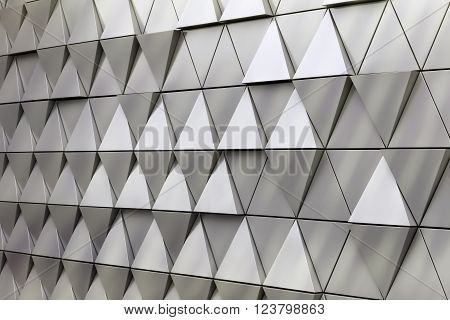 Abstract close-up view of modern aluminum ventilated triangles on facade