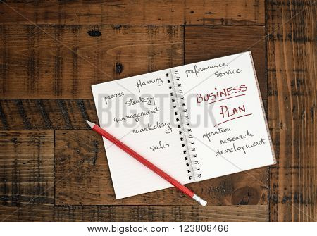 Business Plan - Concept. Hand Written in a notebook