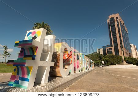 RIO DE JANEIRO, BRAZIL - MARCH 21, 2016: Large colorful sign #CIDADEOLIMPICA (Olympic city) stands in Maua Plaza in the regenerated port area.