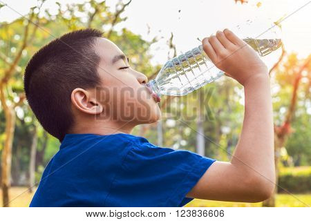 A photo of a Boy drinking water from bottle