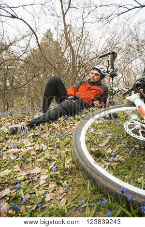 Male cyclist traveling through the woods in early spring.