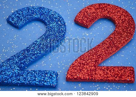 Number twentytwo blue red color over a blue background. Anniversary. Horizontal