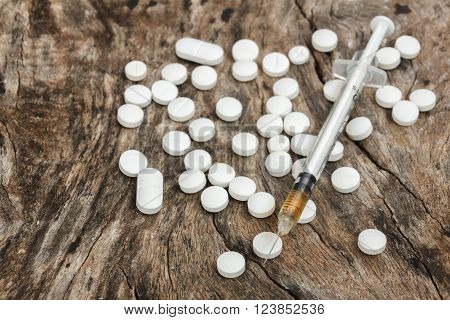 selective focus syringe drug on wood background.