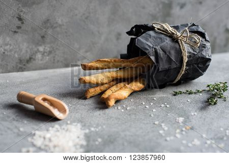 Fresh baked homemade breadsticks grissini with thyme and sea salt.