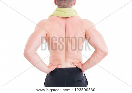 Sportive man holding his lumbar area or lower back after injury and pain