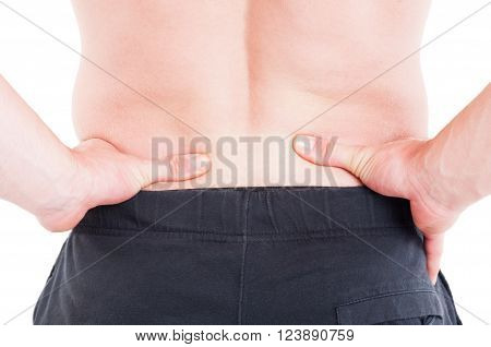 Pain on lower back or lumbar area concept with man holding and pressing fingers