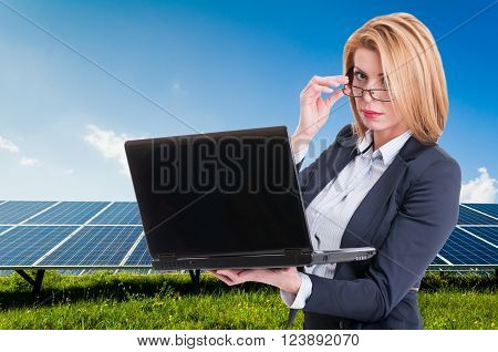 Businesswoman With Solar Power Plant In Background