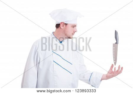 Chef with super powers holding floating knife acting as a super hero cook isolated on white