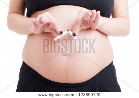 Closeup With Pregnant Woman Hands Breaking Cigarette In Half