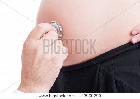 Closeup with stethoscope and pregnant woman belly or tummy on white background