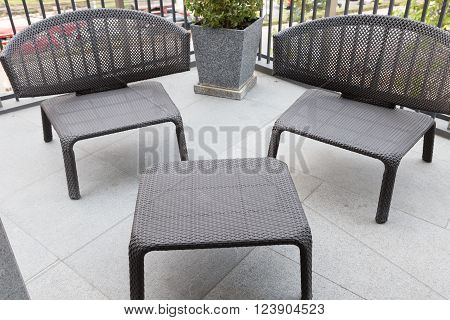 black wicker rattan chair and table at the balcony