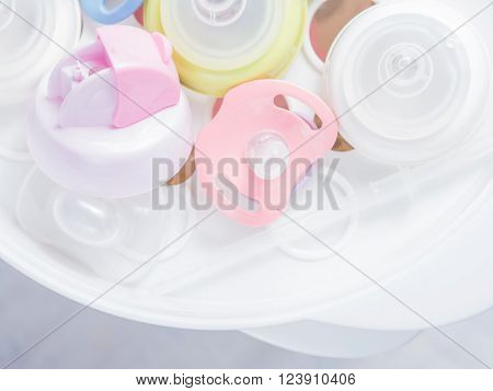 Steam sterilizer and dryer for sterilize baby accessories. Nipple teethers and milk bottles in steam sterilizer and dryer. Steam sterilizer used for sterilize baby accessories by high temperature steam.