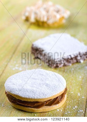Alfajor cookie, a typical Peruvian dessert sitting on light green wooden table top