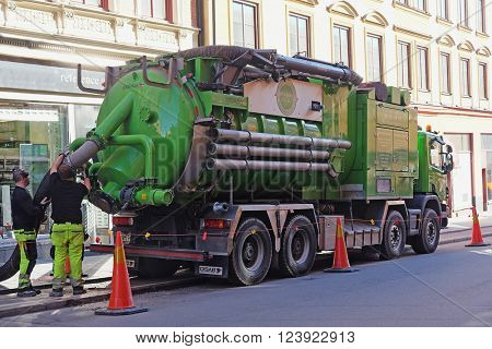 Stockholm, Sweden - March, 16, 2016: sewerage truck works on a street of Stockholm, Sweden