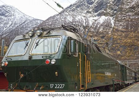 Flam valley, Norway - May 05 2013: a green train at famous Flam railway (Flamsbana) line