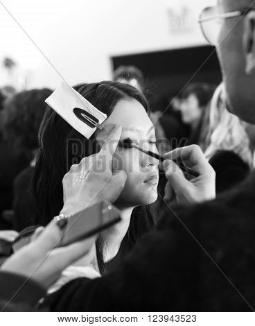 New York, NY - February 13, 2016: Wangy Xin Yu prepares backstage for the Jill Stuart Fall 2016 fashion show during New York Fashion Week