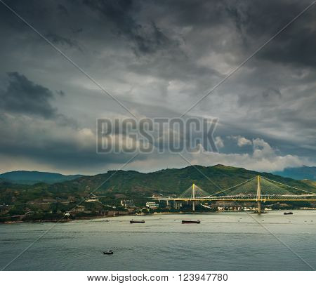 Picturesque landscape with a view on Tsing Ma Bridge, Hong Kong, China. A view with urban and industrial merging with natural mountaings on islands and gorgeous clouds.
** Note: Visible grain at 100%, best at smaller sizes