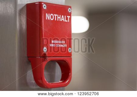 Berlin, Germany - march 30, 2016: Red emergency brake marked with german words 