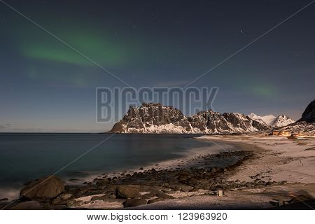 Northern lights over the sea at Utakleiv Beach Lofoten Islands Norway in the winter.