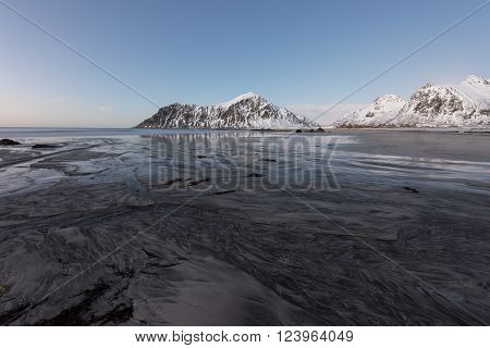 Skagsanden Beach in the Lofoten Islands Norway in the winter at dusk.