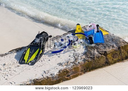 diving, snorkeling, leisure and summer vacations concept - scubas, masks and flippers on beach