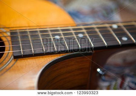 wooden body and fretboard of six strings  acoustic guitar
