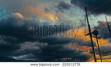 Sailing Yacht Against Dramatic Clouds. Danger Adventure Travel Concept