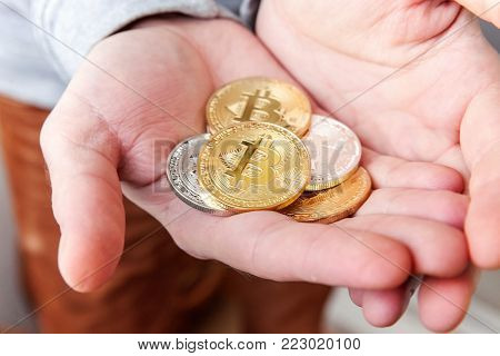 Cryptocurrency golden and silver bitcoins coin in man hand. Electronic virtual money for web banking and international network payment. Symbol of crypto currency