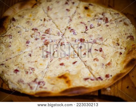 Flammkuchen with ham and cheese in the closeup