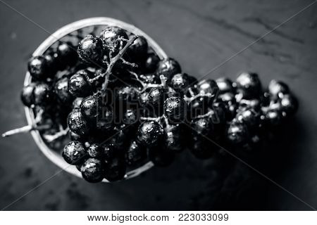Close Up Of Grapes,vitis Vinifera In A Basket On A Brown Wooden Surface.