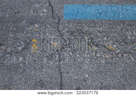 Weathered asphalt texture with traces of paint