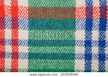 Fabric plaid texture. Green blue and red background