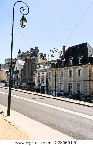 AMBOISE, FRANCE - JULY 8, 2010: lantern and apartment houses on street Quai Charles Guinot in Amboise town. Amboise is commune in the Indre-et-Loire department on the banks of the Loire River