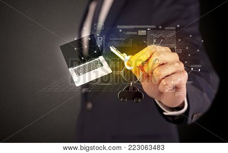 Businessman in suit holding keys with statistics, graphs and icons around