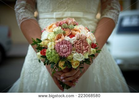 Close up beautiful weding bouquet in bride's hands