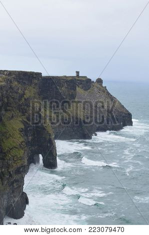 The Beautiful Cliffs Of Moher With Crashing Ocean Waves
