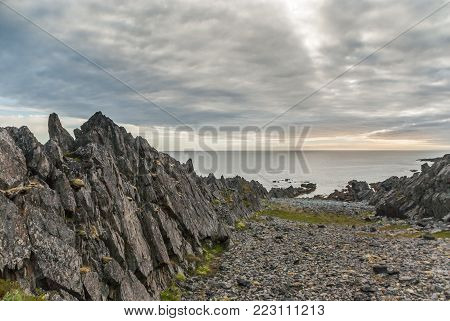 Rocky Cliffs On The Coast Of The Barents Sea Along The Varanger