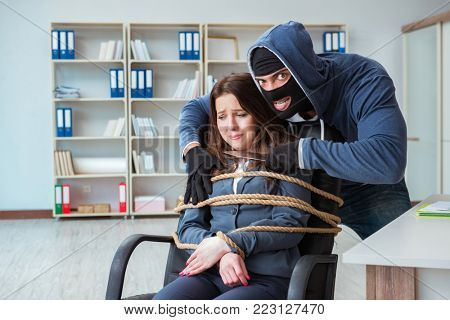 Criminal taking businesswoman as hostage in office