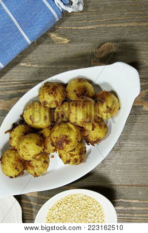 Top down view of Gluten free Moong Daal goli or mung lentil spicy balls cooked in a spicy masala.